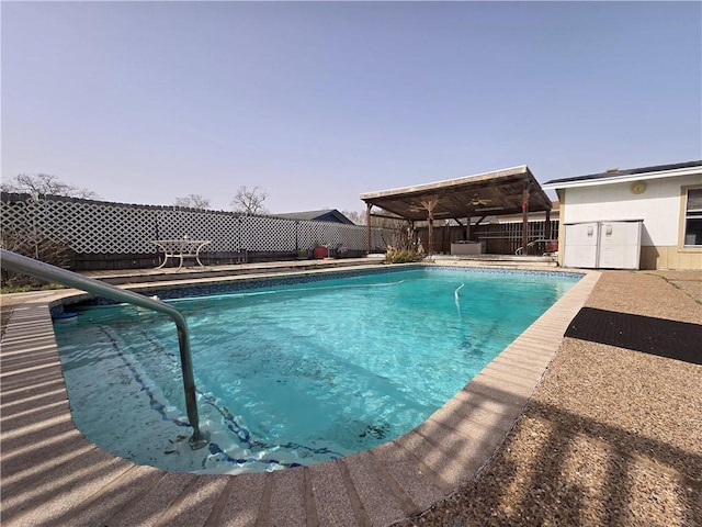 view of swimming pool with a patio, fence, and a fenced in pool