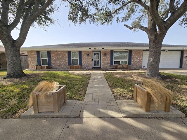 ranch-style house with a garage and brick siding