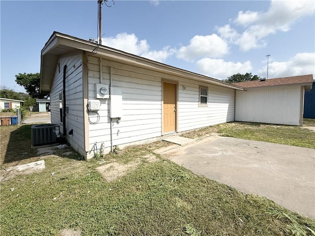 1021 Dona Dr, Corpus Christi, TX 78407 - rear view of house with central AC unit, a patio area, and a lawn