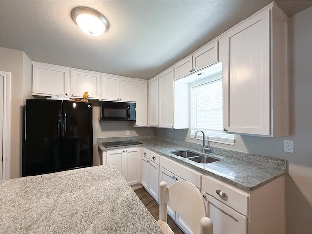 1021 Dona Dr, Corpus Christi, TX 78407 - kitchen with black appliances, a sink, white cabinetry, and dark wood-style flooring