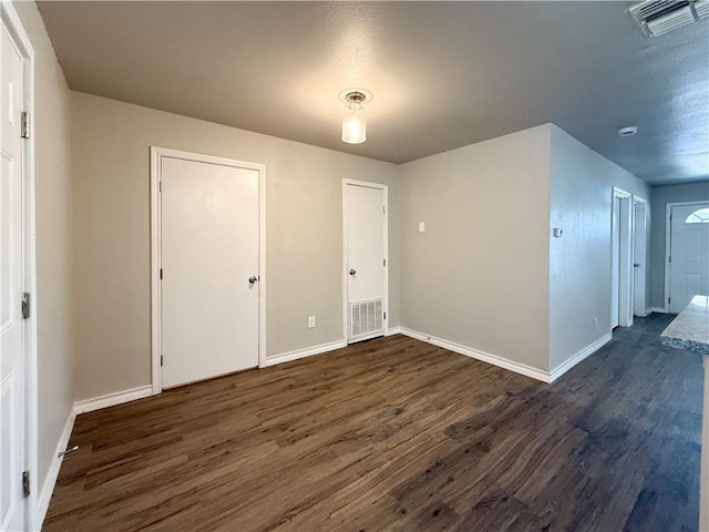 1021 Dona Dr, Corpus Christi, TX 78407 - unfurnished bedroom featuring dark wood finished floors and baseboards