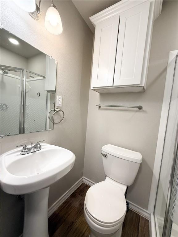 1021 Dona Dr, Corpus Christi, TX 78407 - full bath featuring wood finished floors, a stall shower, and baseboards
