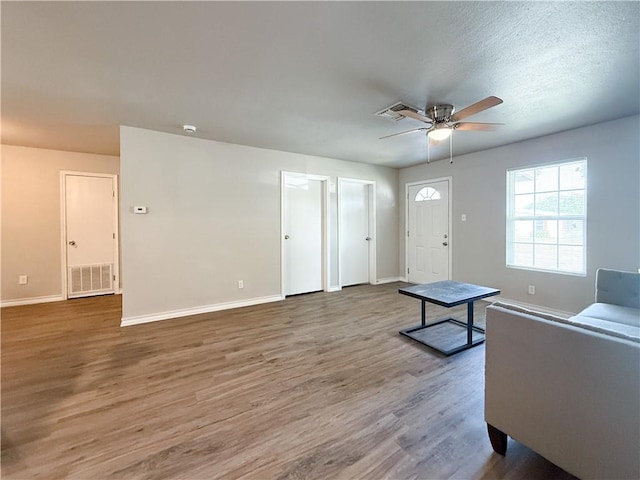 1021 Dona Dr, Corpus Christi, TX 78407 - unfurnished living room with baseboards, ceiling fan, and wood finished floors