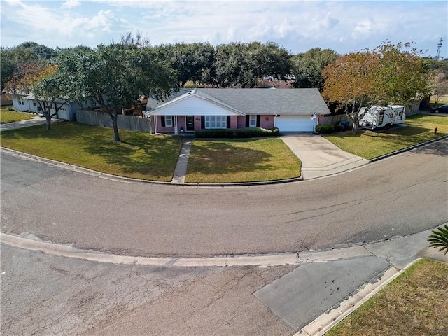 single story home featuring a front lawn and a garage