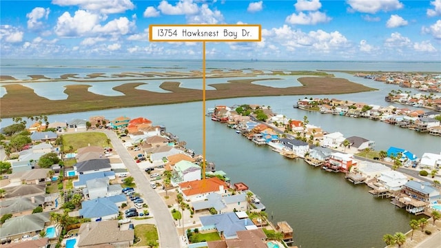 drone / aerial view with a residential view and a water view
