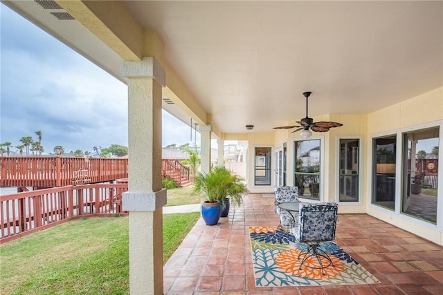 view of patio featuring fence, a ceiling fan, and visible vents