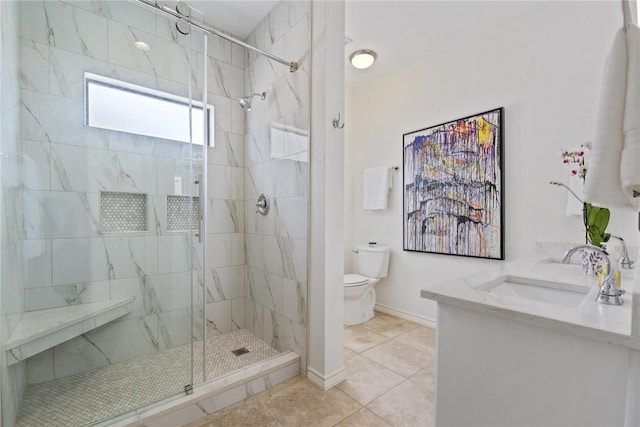 bathroom with toilet, a shower stall, a sink, and tile patterned flooring