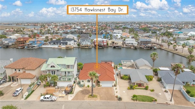 drone / aerial view with a residential view and a water view