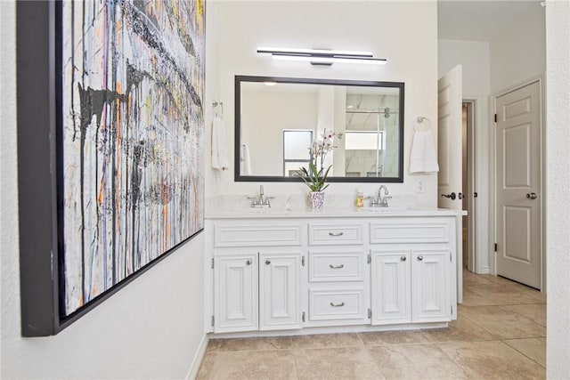 full bathroom featuring double vanity, a sink, walk in shower, and tile patterned flooring