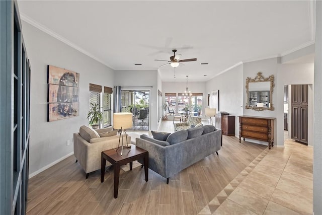 living room featuring baseboards, ornamental molding, ceiling fan with notable chandelier, and light wood-type flooring