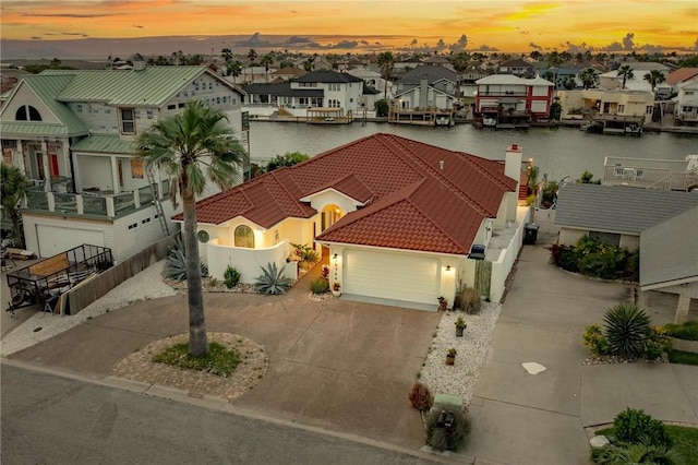 birds eye view of property featuring a water view and a residential view