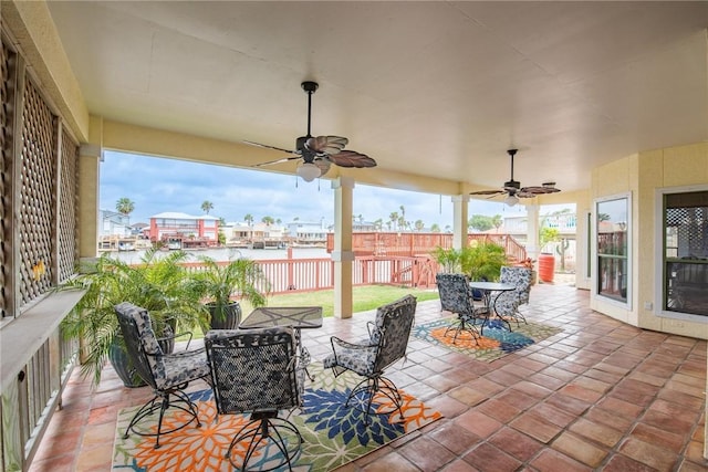 view of patio / terrace with fence, a ceiling fan, and outdoor dining area