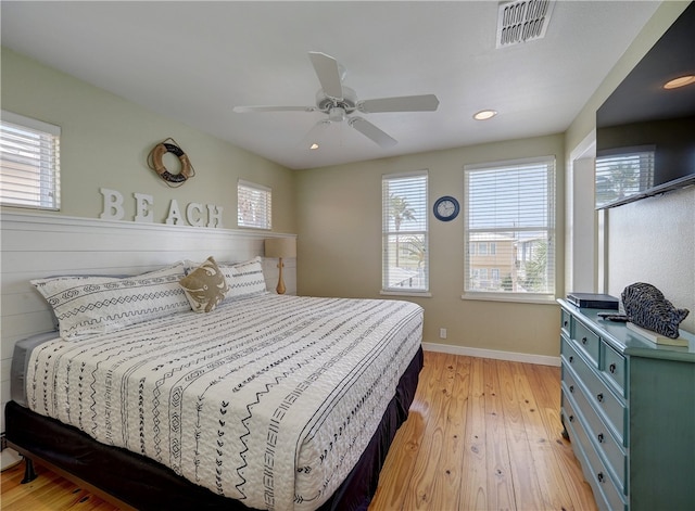 bedroom with light hardwood / wood-style floors and ceiling fan