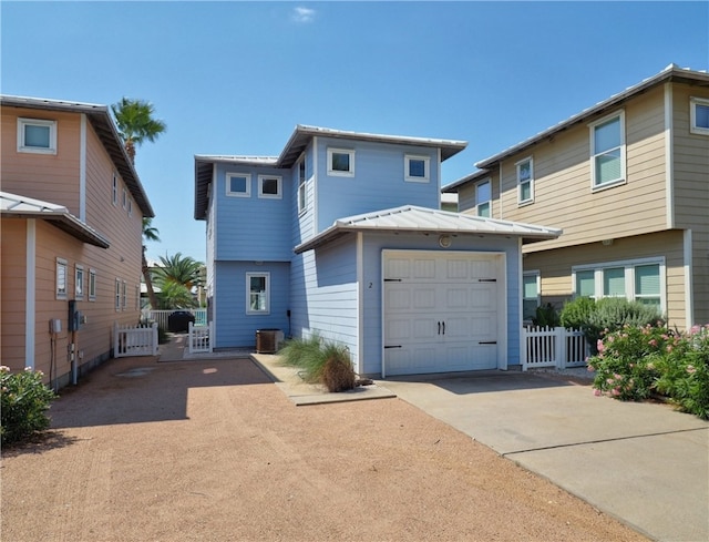 view of front of home with a garage and cooling unit