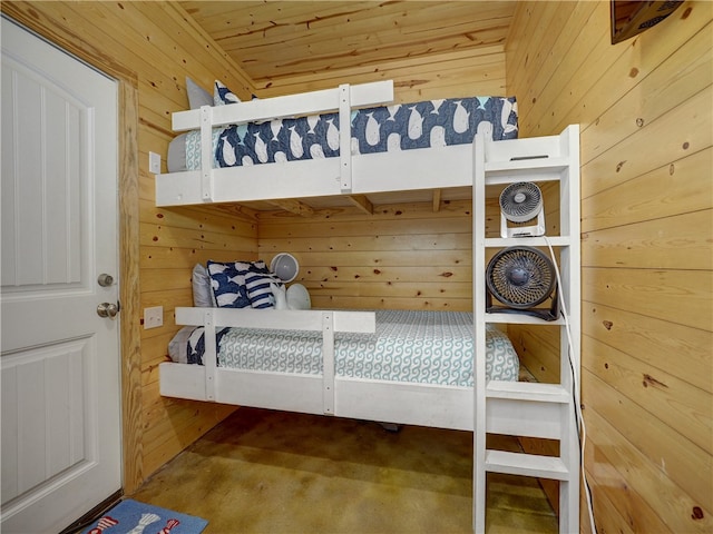 bedroom featuring wood walls, wood ceiling, and carpet flooring