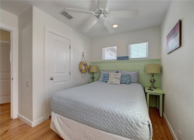 bedroom with ceiling fan and light hardwood / wood-style flooring