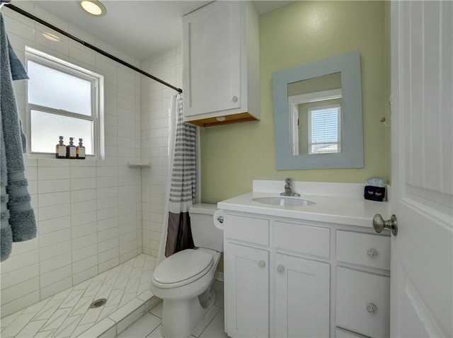 bathroom with a shower with curtain, tile patterned flooring, vanity, and toilet