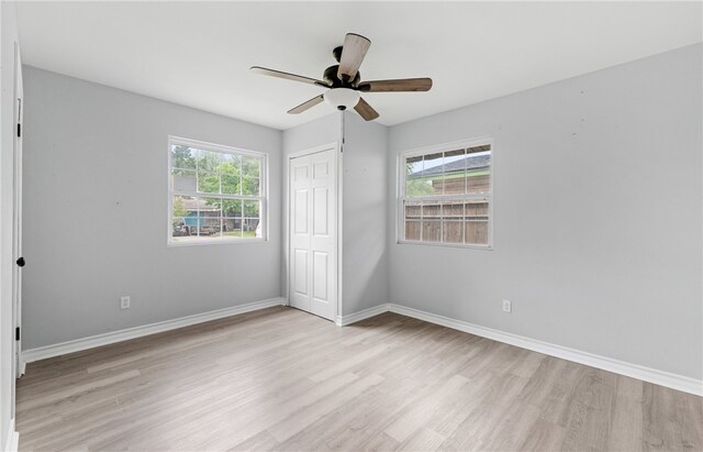 1333 Prince Dr, Corpus Christi, TX 78412 - unfurnished bedroom featuring light wood-style flooring, a closet, baseboards, and a ceiling fan
