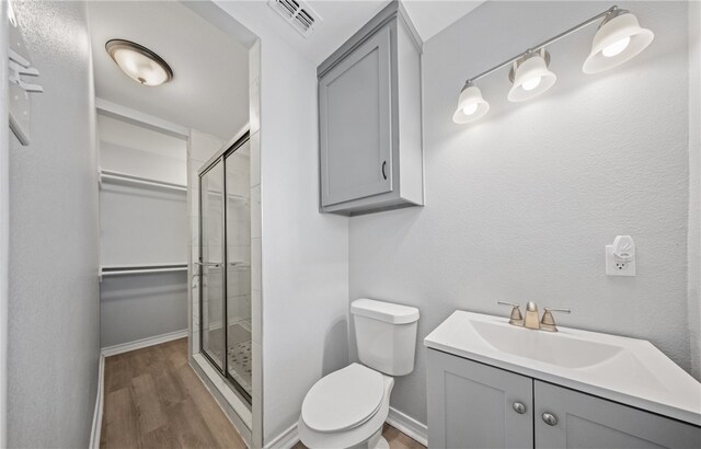 1333 Prince Dr, Corpus Christi, TX 78412 - full bath with a shower stall, toilet, wood finished floors, baseboards, and vanity