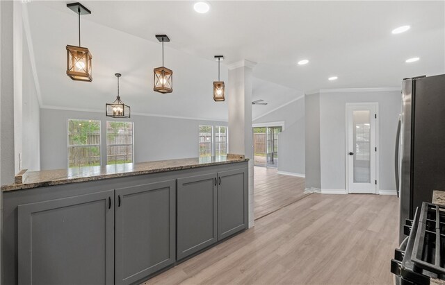 1333 Prince Dr, Corpus Christi, TX 78412 - kitchen featuring gray cabinets, freestanding refrigerator, ornamental molding, light stone countertops, and light wood-style floors