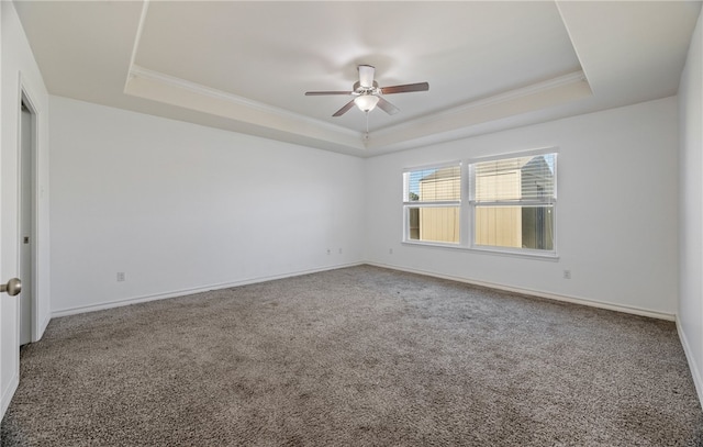 carpeted spare room featuring baseboards, crown molding, and a tray ceiling