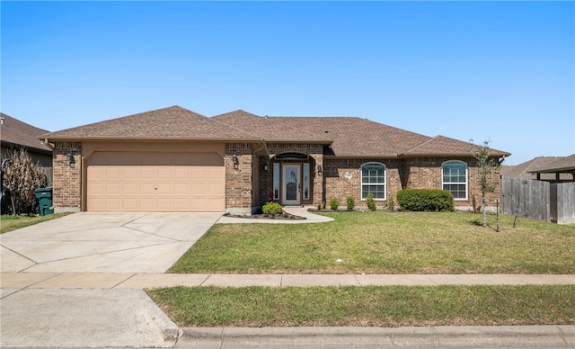 ranch-style house featuring driveway, fence, an attached garage, a front yard, and brick siding