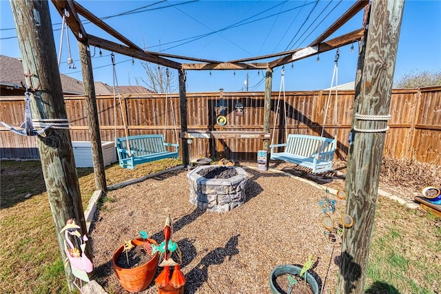 view of yard with a fenced backyard and an outdoor fire pit