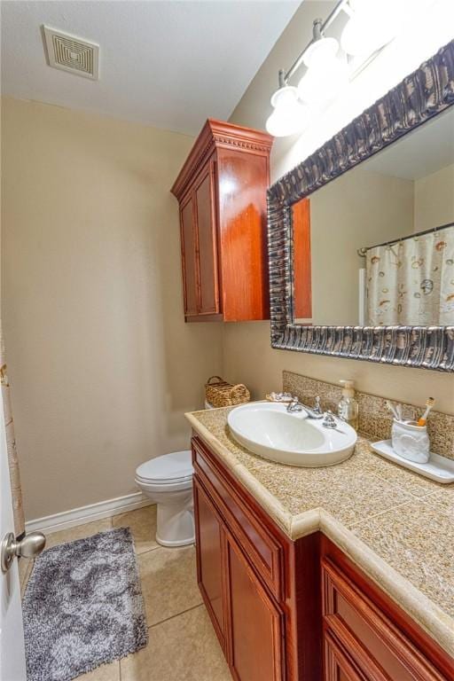 full bathroom with vanity, baseboards, visible vents, tile patterned floors, and toilet