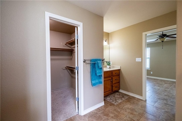 14426 Pentridge Dr, Corpus Christi, TX 78410 - bathroom featuring vanity, a spacious closet, and ceiling fan