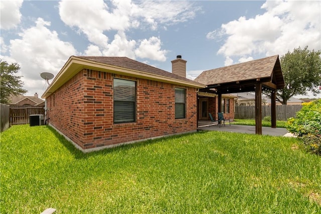 14426 Pentridge Dr, Corpus Christi, TX 78410 - back of house with a patio, a fenced backyard, brick siding, and a chimney