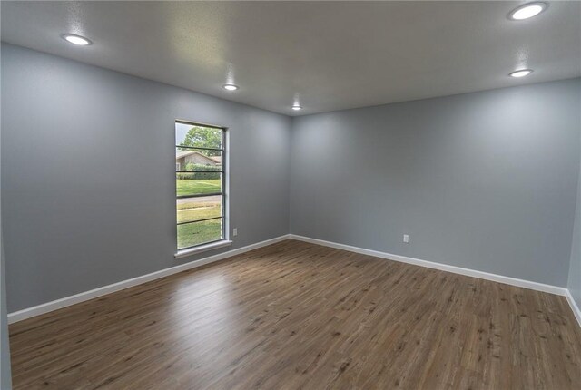 3809 Capri Dr, Corpus Christi, TX 78415 - empty room featuring dark wood-type flooring, baseboards, and recessed lighting