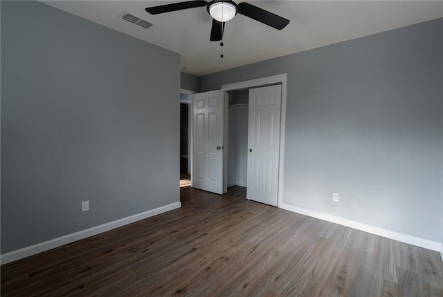 3809 Capri Dr, Corpus Christi, TX 78415 - unfurnished bedroom with dark wood finished floors, baseboards, a closet, and a ceiling fan