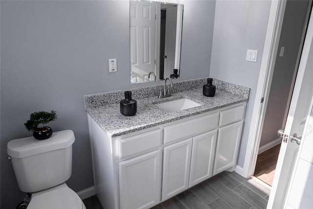 3809 Capri Dr, Corpus Christi, TX 78415 - half bath featuring vanity, toilet, and baseboards