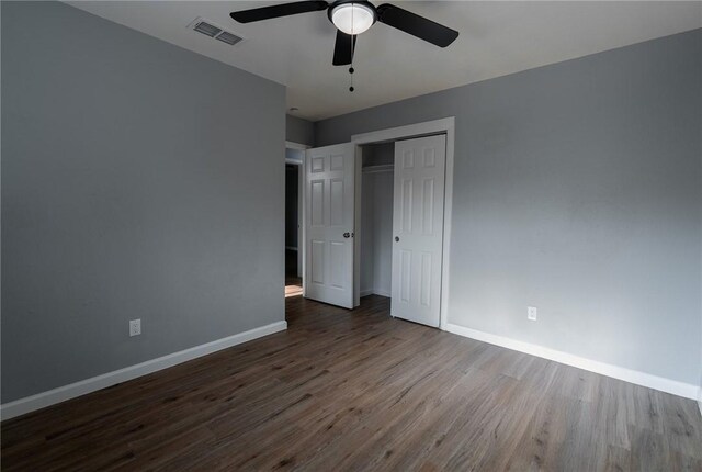 3809 Capri Dr, Corpus Christi, TX 78415 - unfurnished bedroom with dark wood finished floors, baseboards, a closet, and a ceiling fan