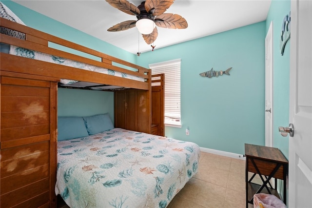 bedroom featuring light tile patterned floors and baseboards