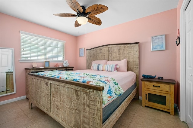 bedroom featuring light tile patterned floors, ceiling fan, and baseboards