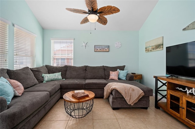 living room with vaulted ceiling, a ceiling fan, and light tile patterned flooring