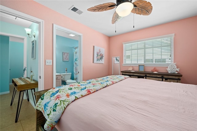 tiled bedroom with connected bathroom, visible vents, and a ceiling fan