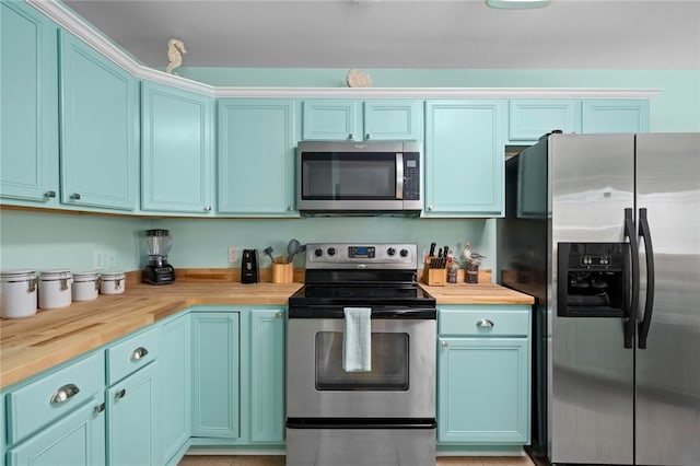 kitchen featuring stainless steel appliances and wooden counters