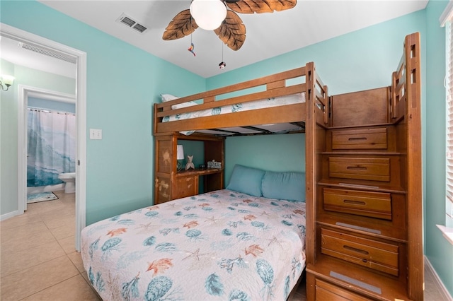 bedroom featuring light tile patterned floors, ensuite bathroom, visible vents, and baseboards