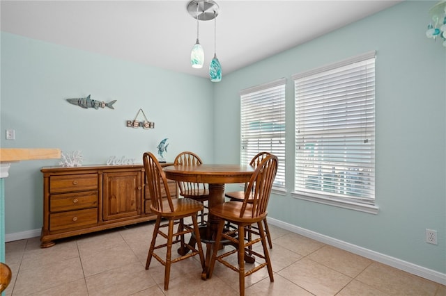 dining room featuring light tile patterned floors and baseboards