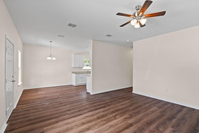 2201 Morris St, Corpus Christi, TX 78405 - unfurnished living room featuring ceiling fan, dark wood finished floors, and a chandelier