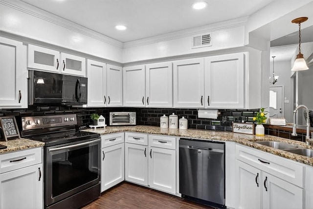 7609 Stony Brook Dr, Corpus Christi, TX 78413 - kitchen with appliances with stainless steel finishes, white cabinets, light stone countertops, decorative backsplash, and ornamental molding