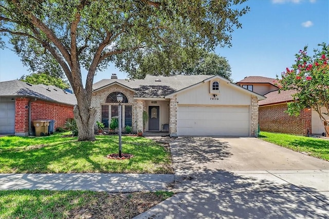 7609 Stony Brook Dr, Corpus Christi, TX 78413 - view of front facade with stone siding, an attached garage, a front lawn, and concrete driveway