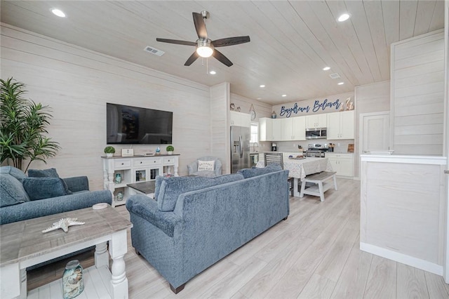 living room featuring ceiling fan, light hardwood / wood-style flooring, and wood ceiling