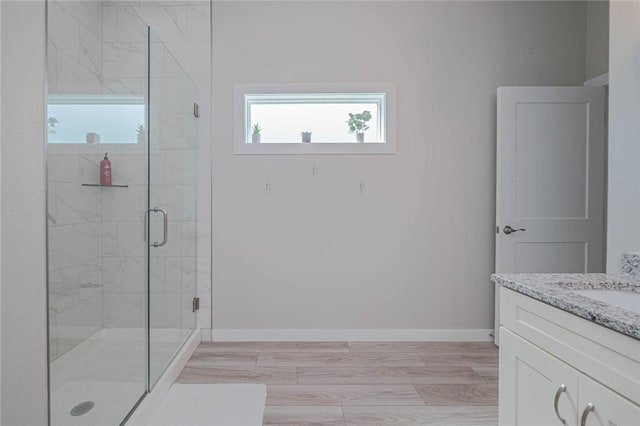 bathroom featuring vanity, hardwood / wood-style flooring, and walk in shower