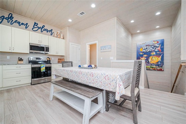 kitchen with white cabinets, light stone countertops, wood ceiling, and appliances with stainless steel finishes