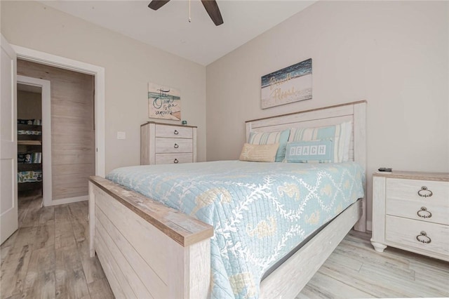 bedroom with ceiling fan and light hardwood / wood-style floors