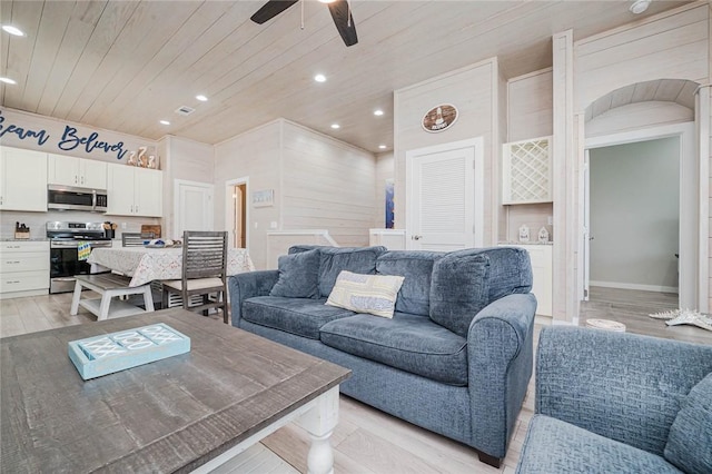 living room with ceiling fan, light hardwood / wood-style floors, and wooden ceiling