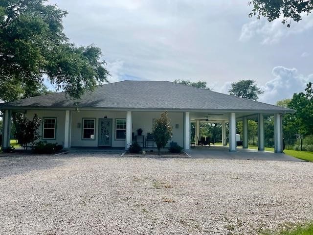 705 Monkey Rd, Rockport, TX 78382 - view of front of home with driveway, a porch, and a carport